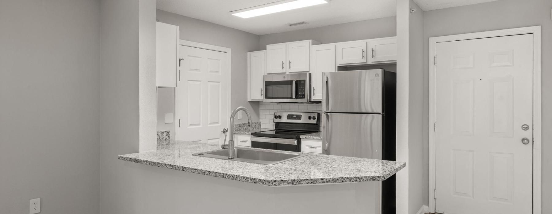 a kitchen with white cabinets