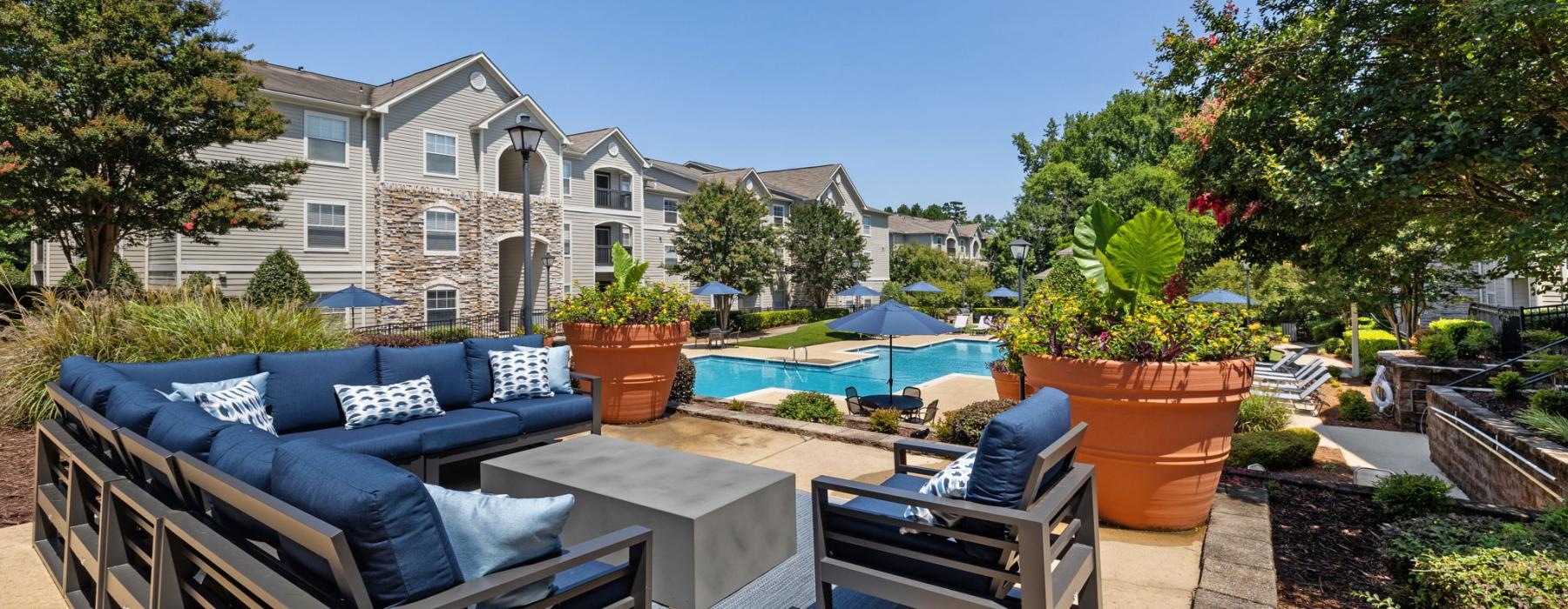 a patio with a pool and chairs