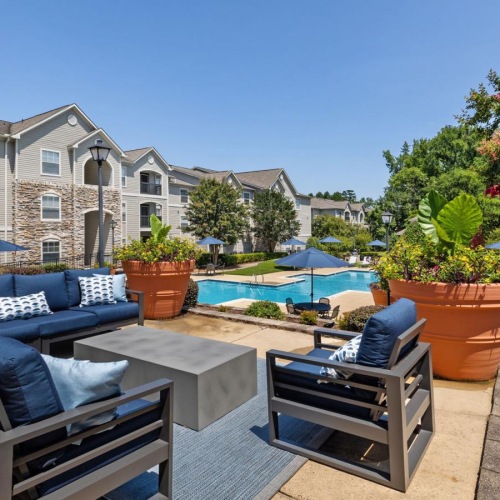 a patio with a pool and chairs