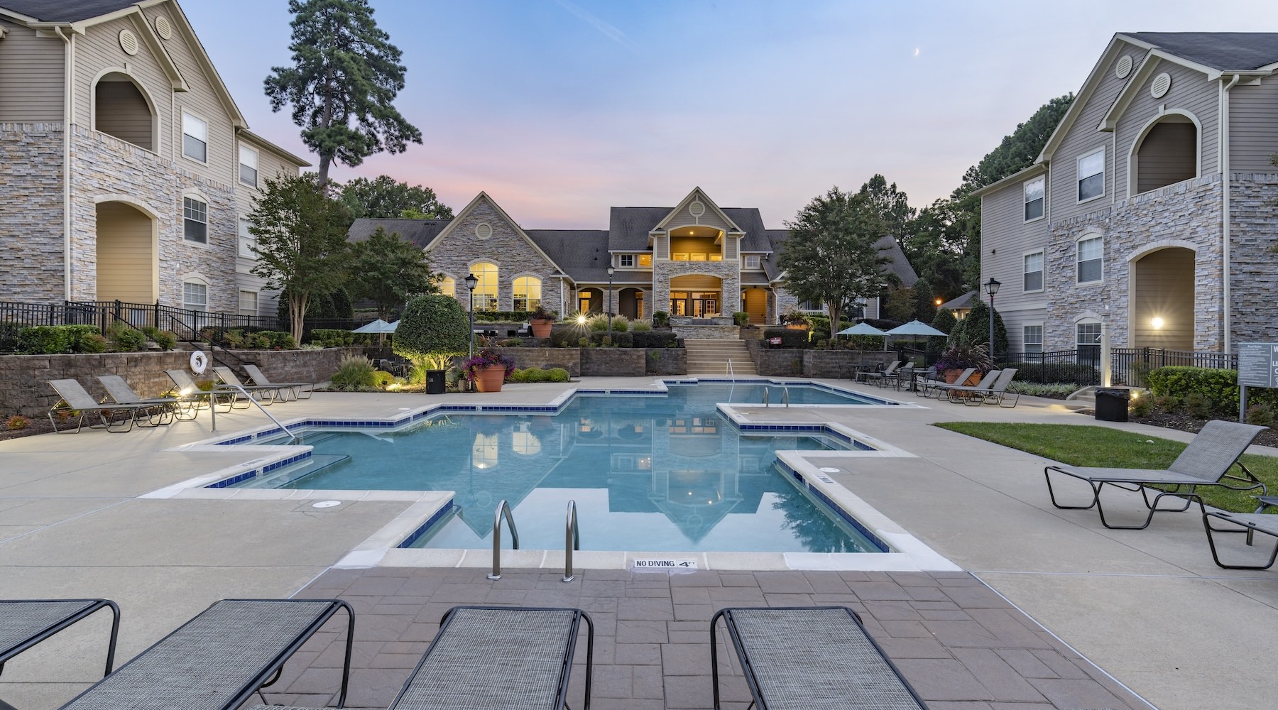 resort style pool with seating in a courtyard