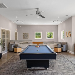 a room with a pool table and couches