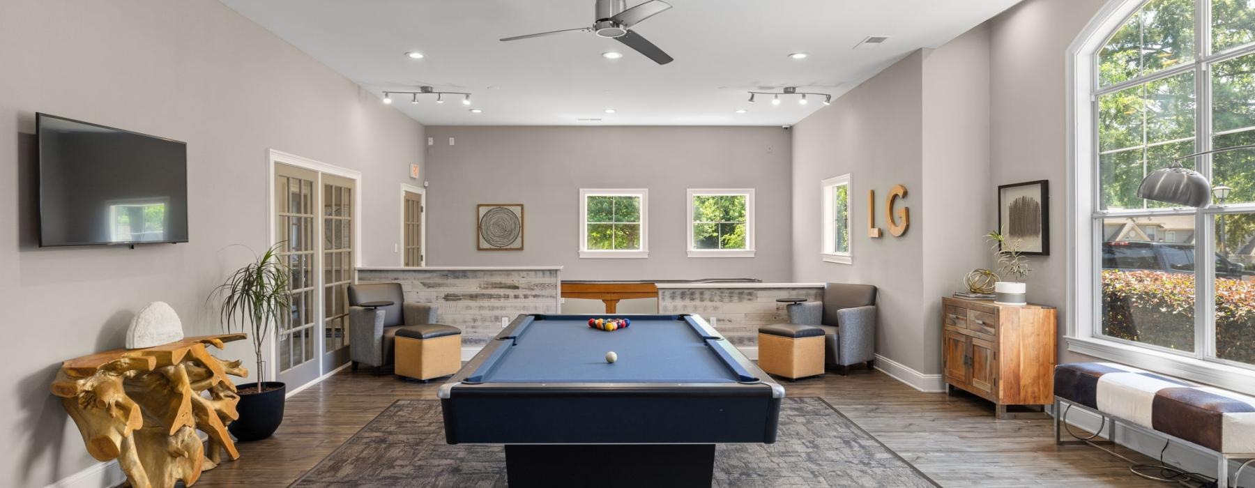 a room with a pool table and couches